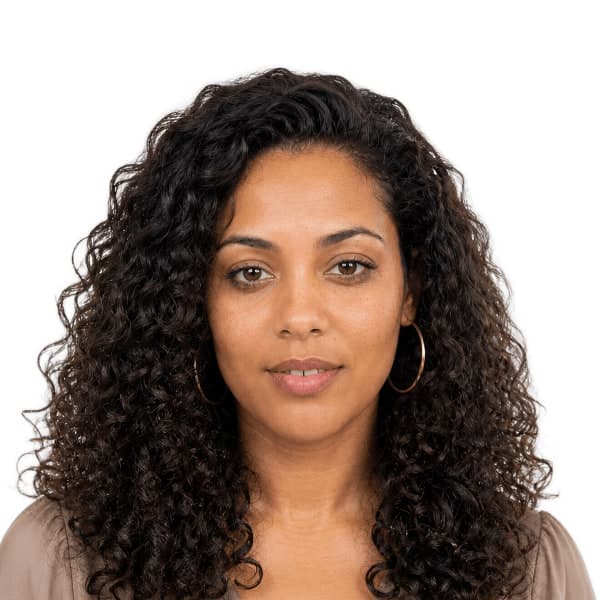 Finished document photo: a woman with long curly hair on a plain white background, from a phone snapshot taken in harsh sunlight