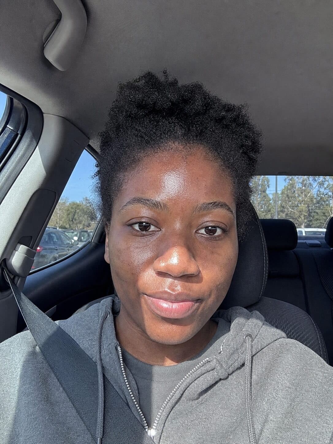 A selfie taken in a parked car in harsh sun and the document photo made from it