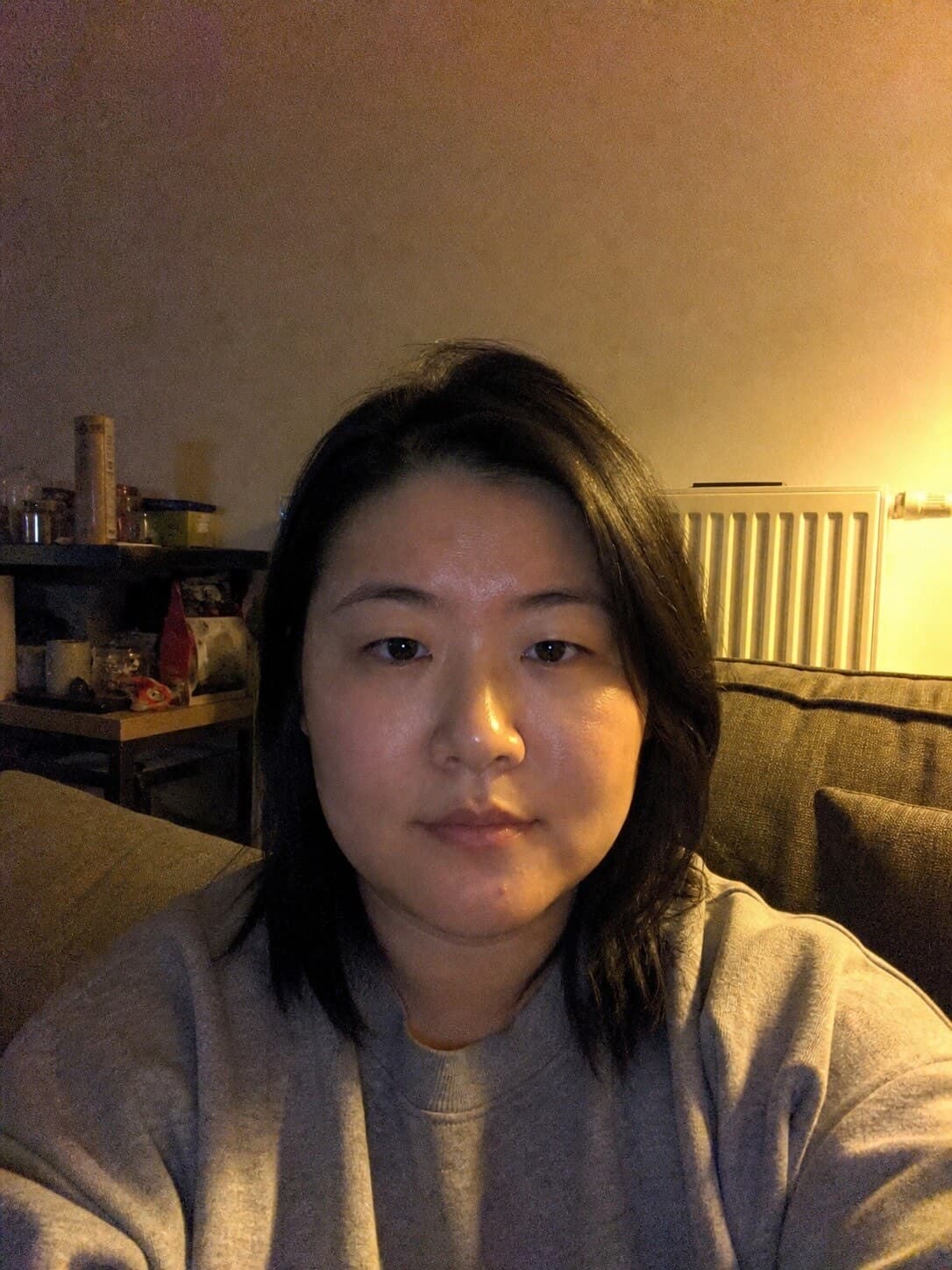 A living room selfie by lamplight and the document photo made from it